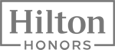 The image shows the logo for Hilton Honors, with "Hilton" in large text inside a rectangle and "Honors" below in smaller text.